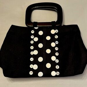Tianni purse, black plastic handle with super cute black and white button front